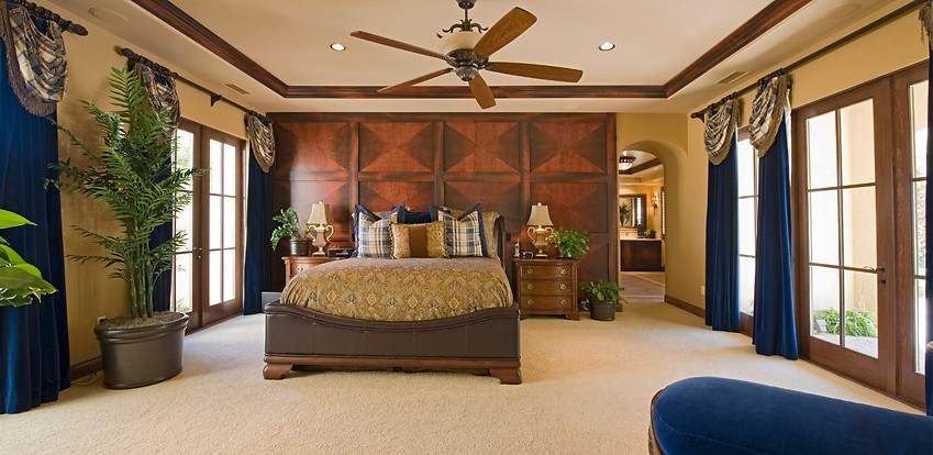 Elegant master bedroom with ceiling fan and French doors Elegant master bedroom with ceiling fan and French doors